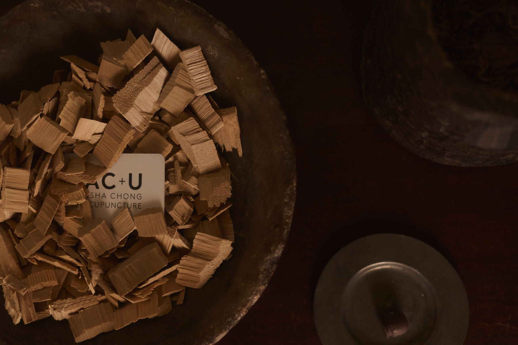 Asha Chong Acupuncture business card in a bowl